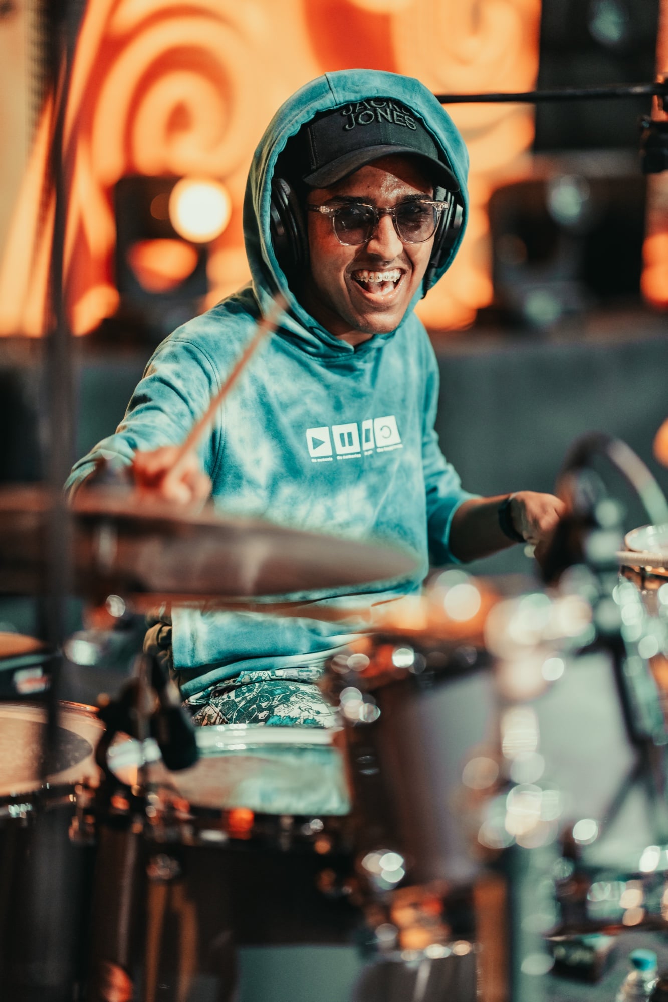 Sai grinning behind his drum kit